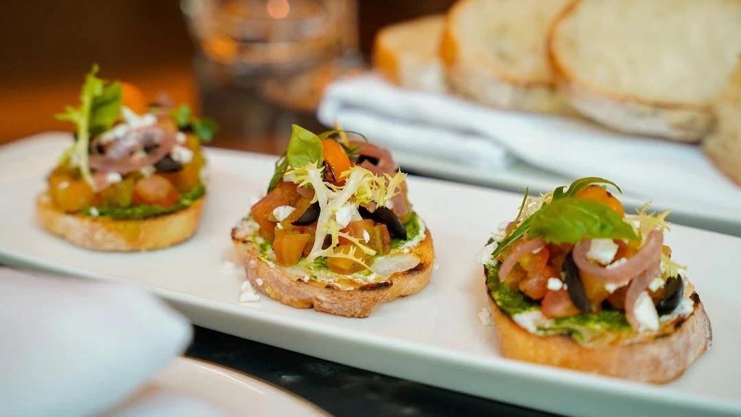 Bruschetta with heirloom tomato, feta and pesto on sourdough at Theodore