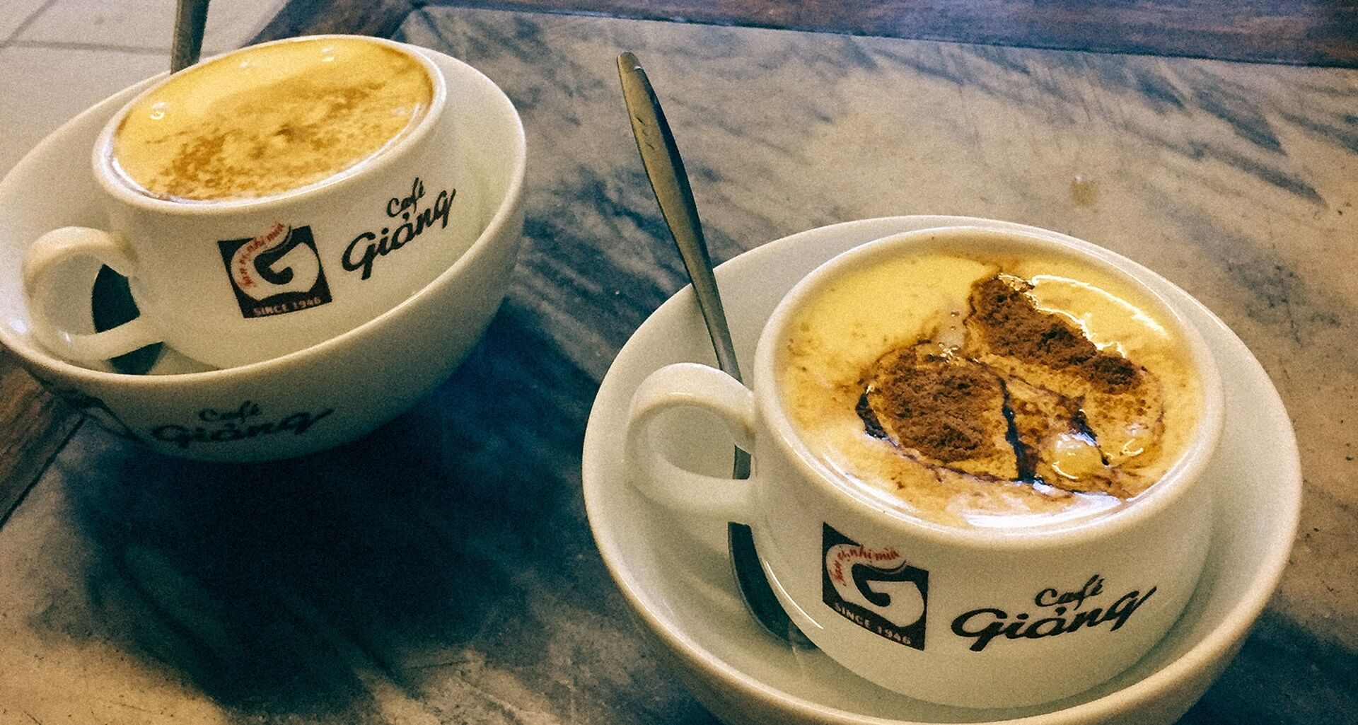 Two creamy cups of egg coffee at Cafe Giang on Nguyen Huu Huan Street in Hanoi.