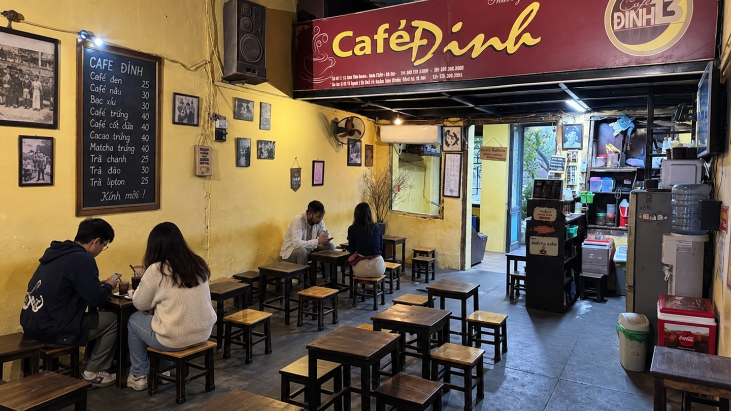 Cafe Dinh's yellow-walled interior with customers seated by the window.