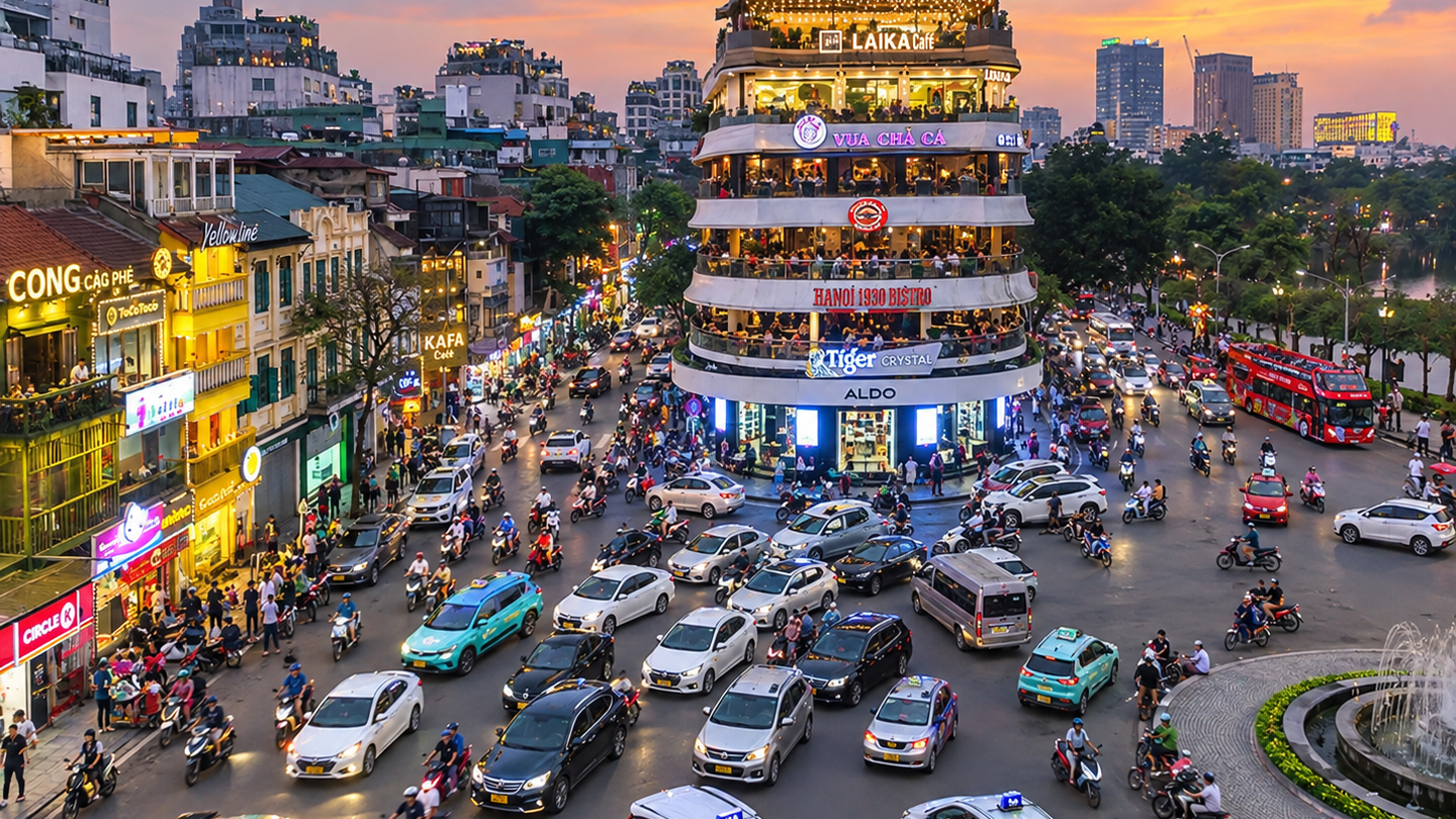 Evening traffic and illuminated buildings near Hoan Kiem Lake