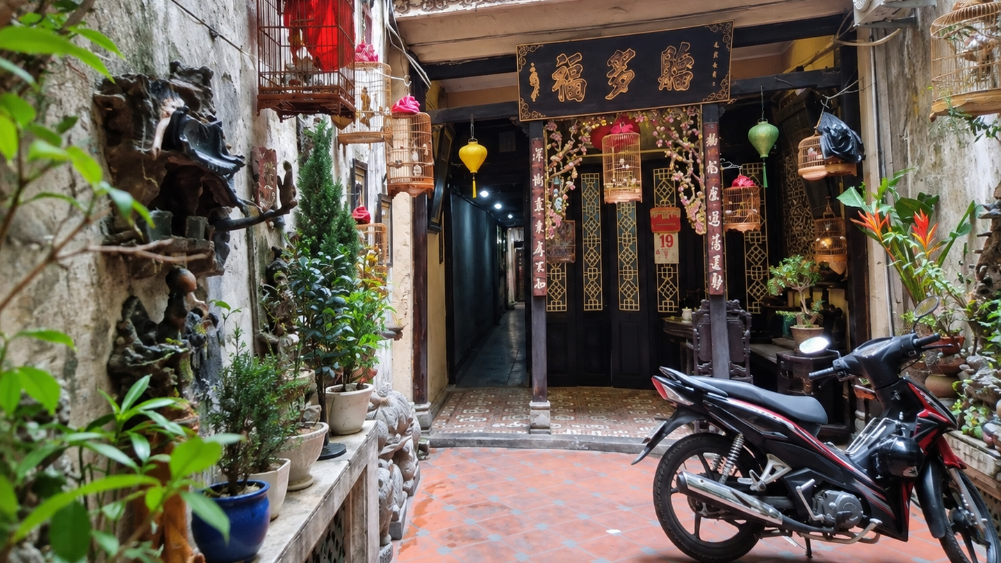 Plant-lined entrance to Cafe Pho Co on Hang Gai Street in Hanoi.