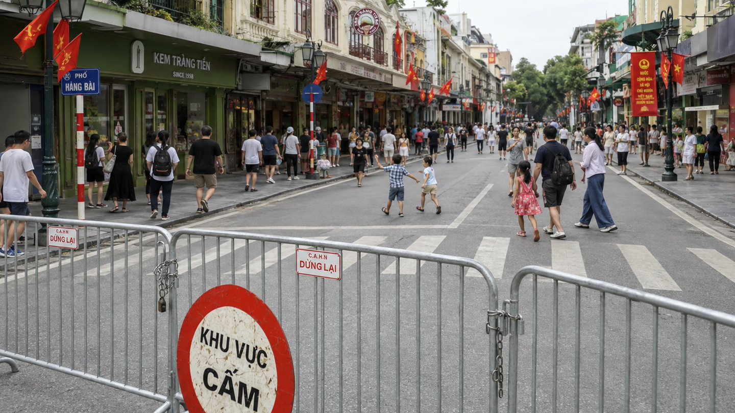 Temporary road barrier on a Hanoi street closed to vehicles during weekend walking hours.