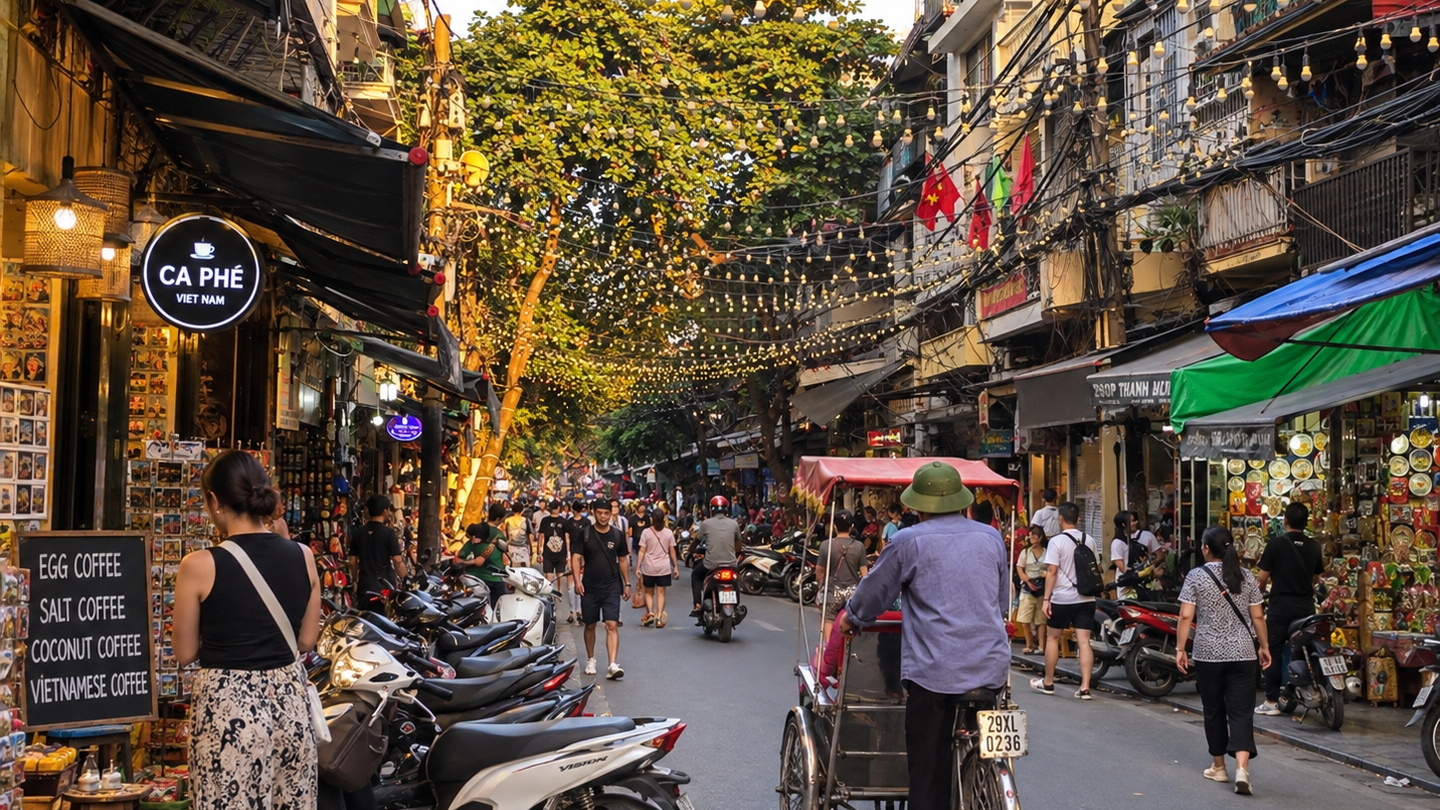 Lanterns and flags hang above a tree-lined Old Quarter street in Hanoi.