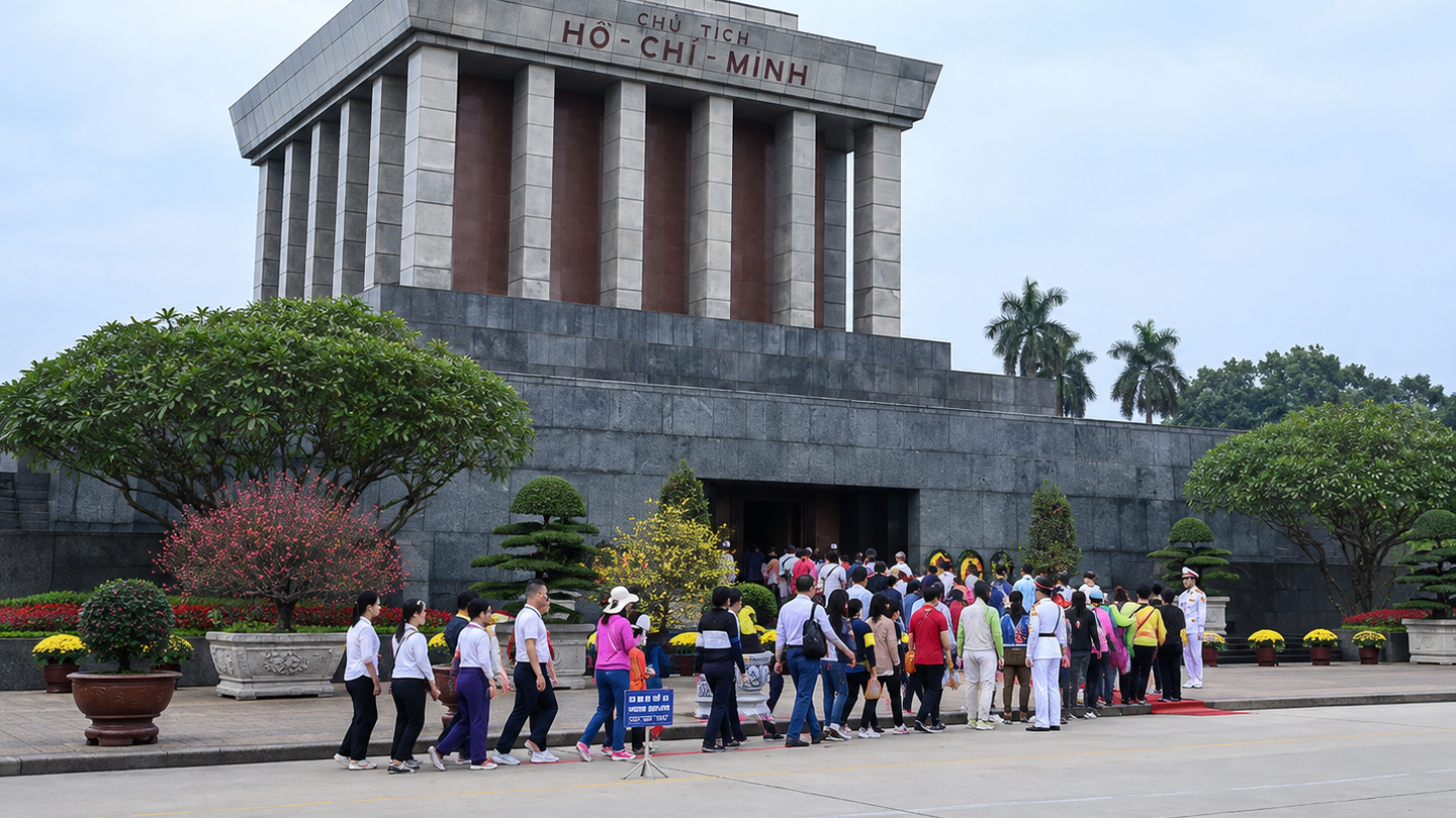 Visitors walk across Ba Dinh Square in front of the Ho Chi Minh Mausoleum.