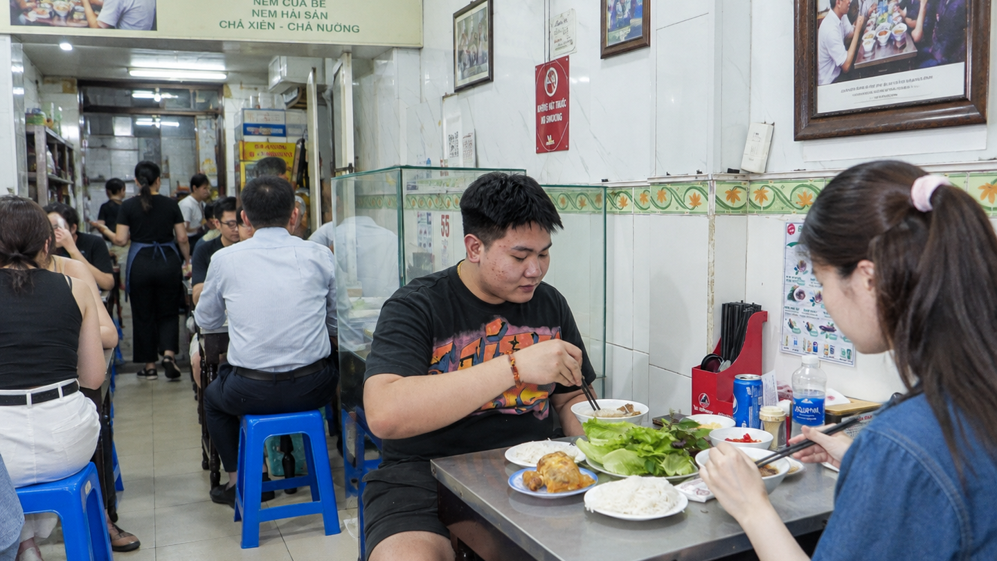 Diners share a meal inside Bún Chả Hương Liên in Hanoi.
