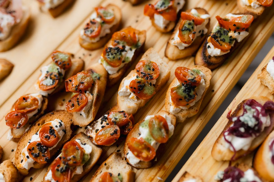 Small savory canapés arranged on boards at a hotel restaurant in Hanoi.