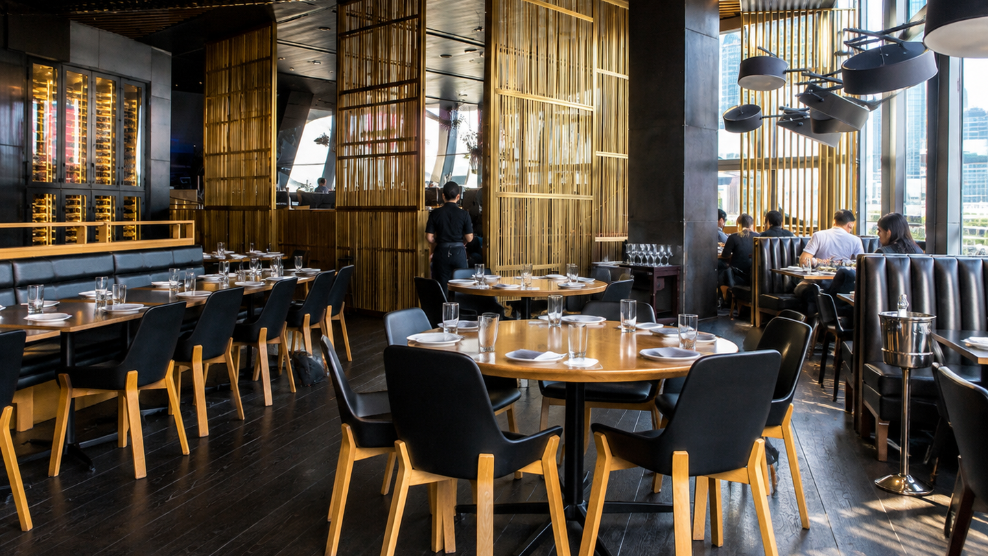 Guests dine beneath bamboo screens inside Quán Ăn Ngon in Hanoi.