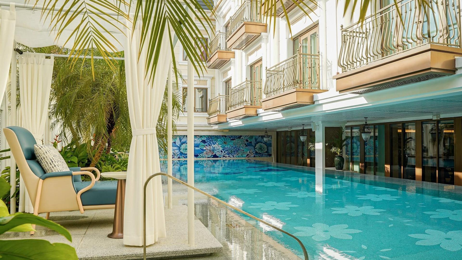 The outdoor pool by day beneath the guest room balconies